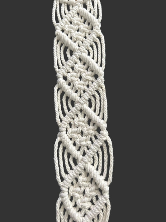 White macrame plant hanger with signature square knot diamond patterns by Twisted Threads Au, designed for holding potted plants.