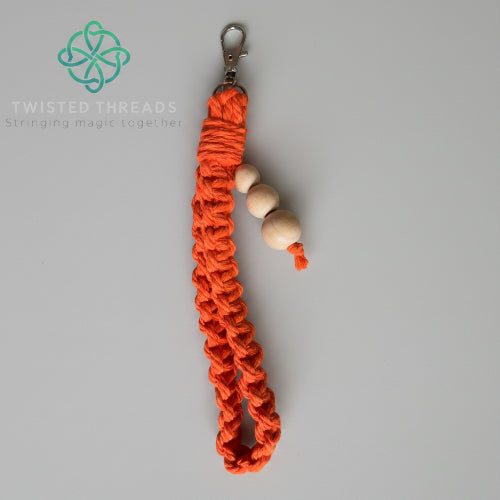 Yellow large square knot wristlet keychain from Twisted Threads Au keychain collection, featuring a woven design and metal clasp.