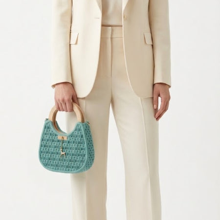 Twisted Threads Au Threadline 07 Labyrinth Loop Handbag held in hand, showcasing its intricate woven design and stylish structure.
