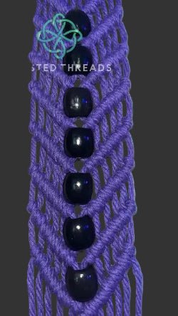 White V-shaped macrame plant hanger with beads by Twisted Threads Au, showcasing intricate knotwork and a stylish design.