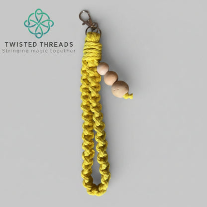 Large yellow Square Knot wristlet from Twisted Threads Au keychain collection, featuring a woven design and sturdy attachment.